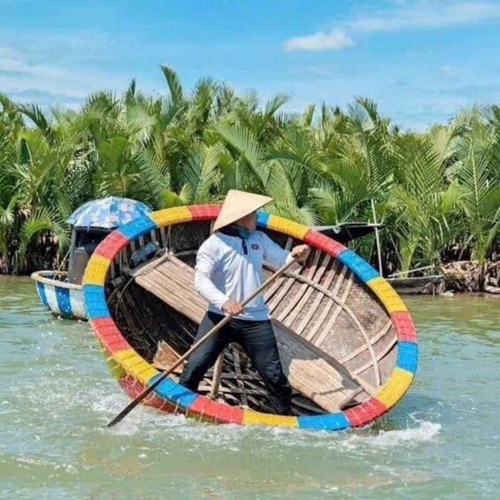 A person rowing a colorful boat with a conical hat, surrounded by palm trees. 2