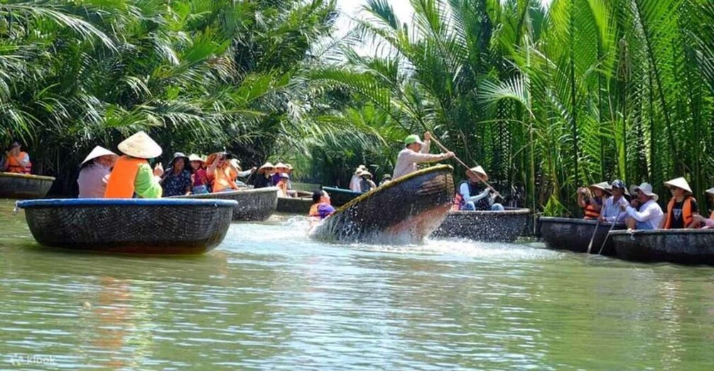 People in boats on a river surrounded by palm trees. 1