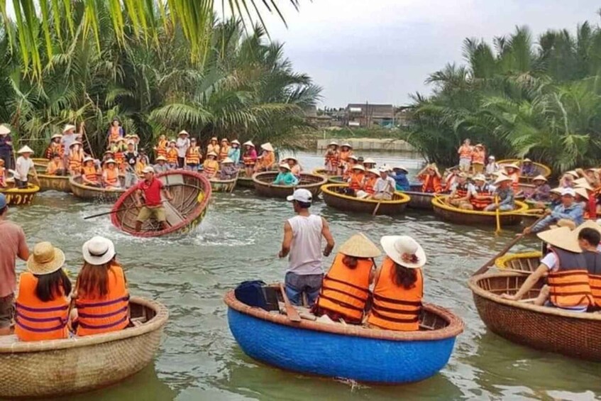 A group of people in traditional boats on a river surrounded by palm trees. 5