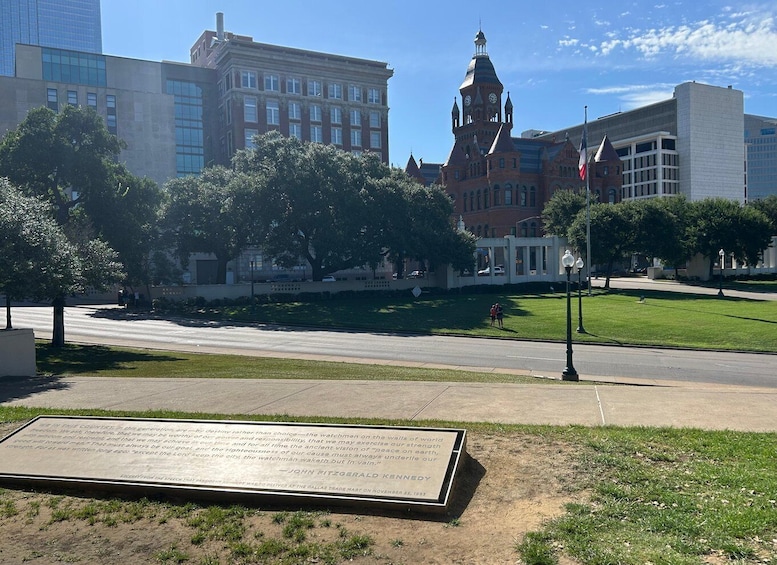 A cityscape with a historic building, a modern skyscraper, and a memorial plaque. 4