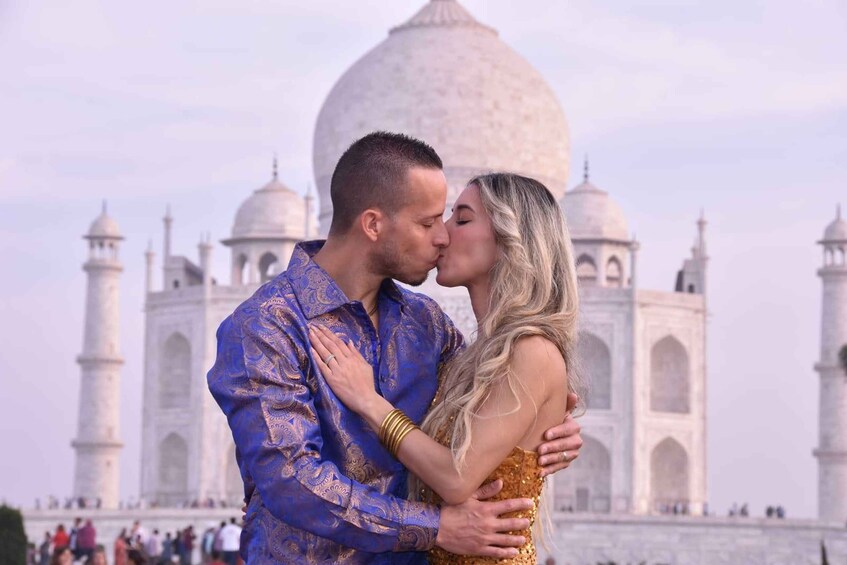 A couple embracing in front of the Taj Mahal. 3