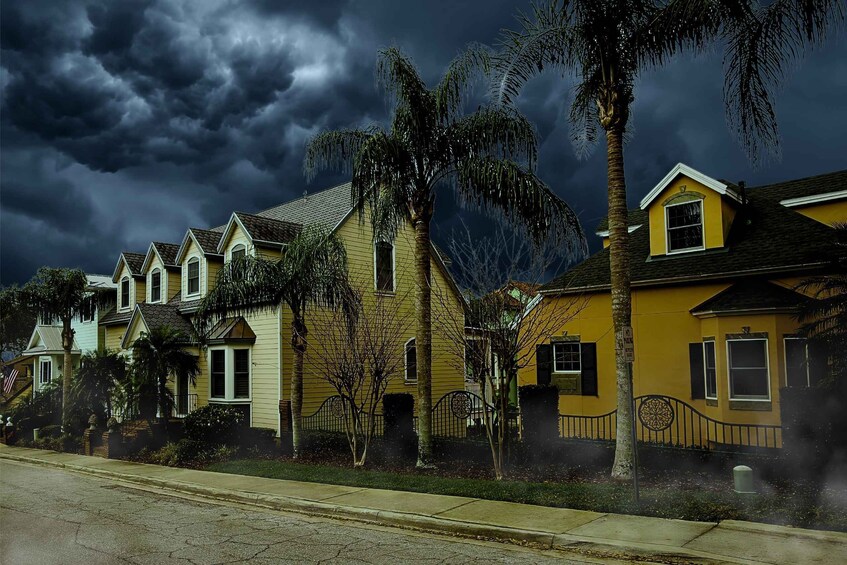 A row of yellow houses with a stormy sky. 5
