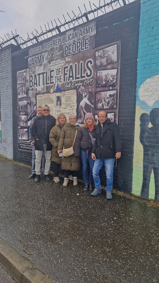 A mural commemorating the Battle of the Falls, featuring historical photographs and text. 1