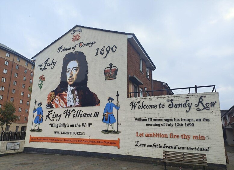 A mural on a building with historical figures and text. 4