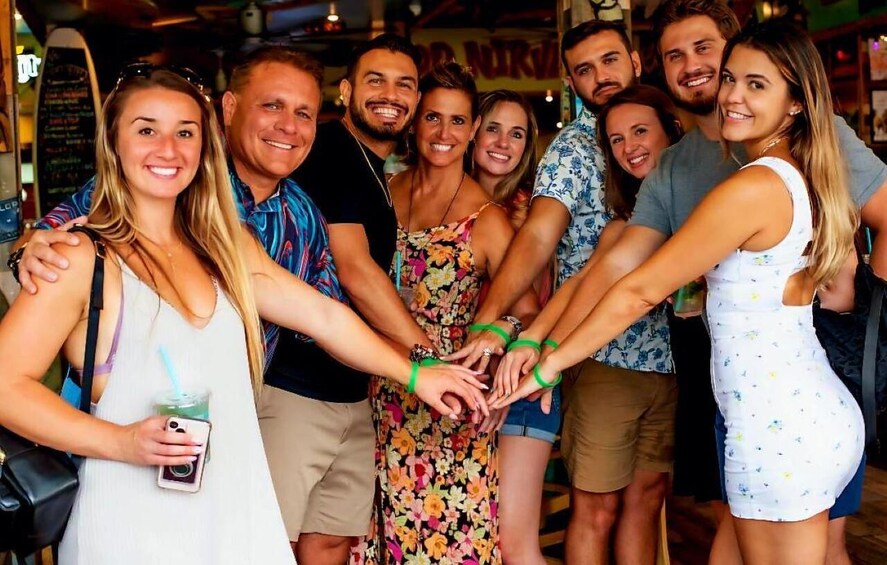 A group of people holding hands in a casual indoor setting. 1
