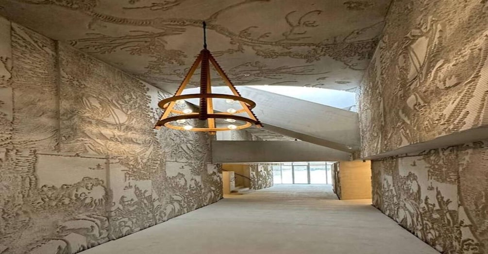 A hallway with ornate wall murals and a hanging light fixture. 3