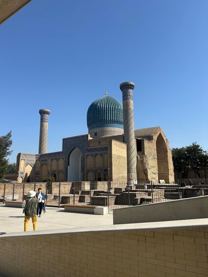 A historic building with a large dome and two tall minarets. 2