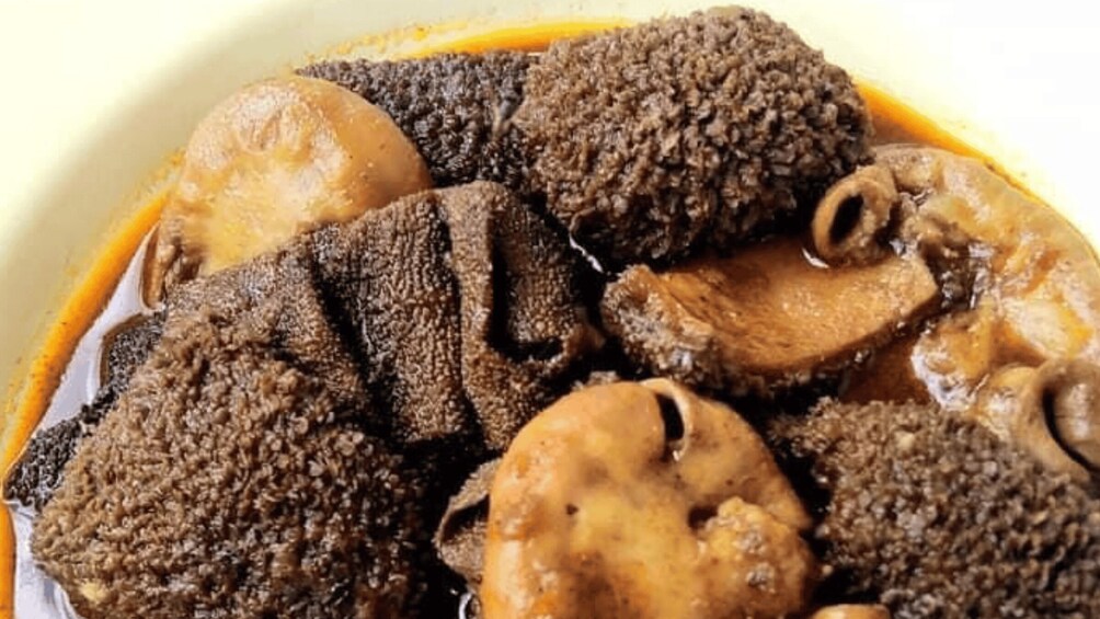 A dish with mushrooms and chunks of meat in a sauce. 4