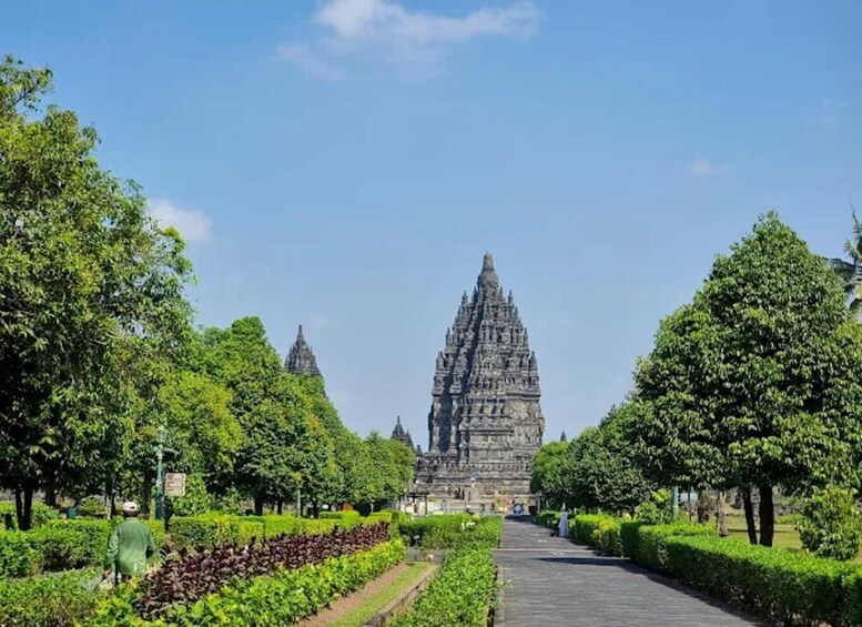 A temple complex with a central structure and smaller buildings, surrounded by well-maintained gardens and pathways. 2