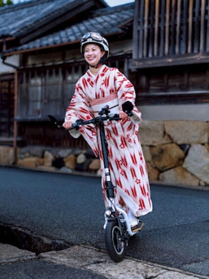 A person riding a scooter on a street. 3