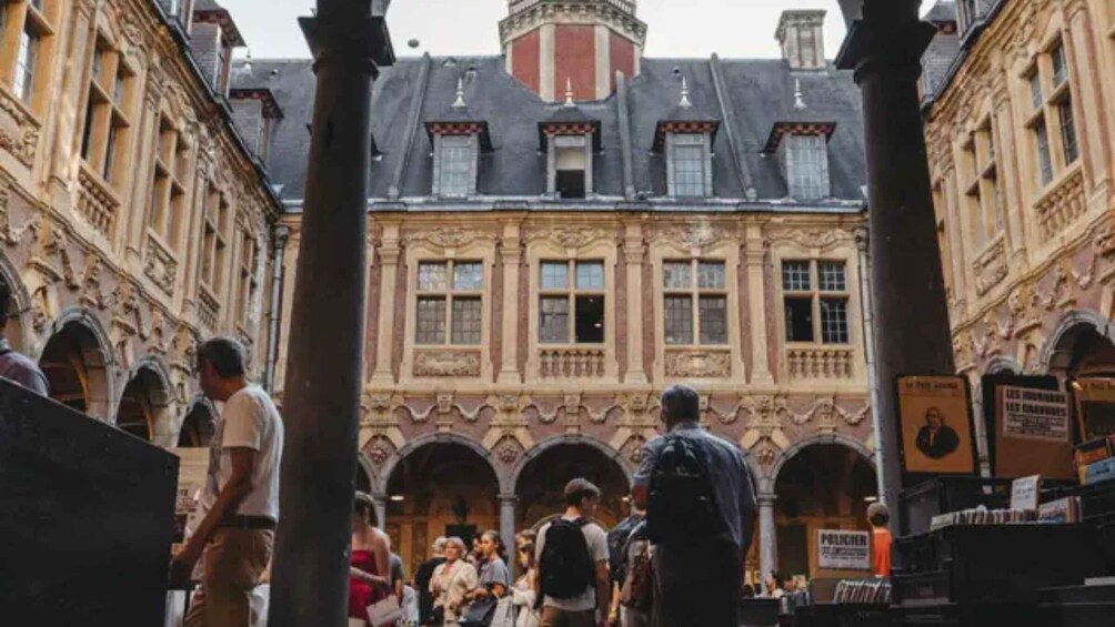 A historic building with ornate architecture, including arched walkways and a central courtyard. 5