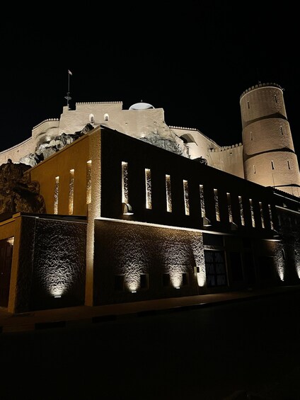 A historic fortress with illuminated towers and a prominent minaret. 5