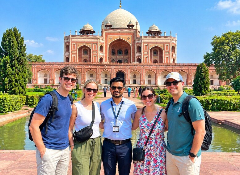 A group of people standing in front of a large, ornate building with domes and arches. 5