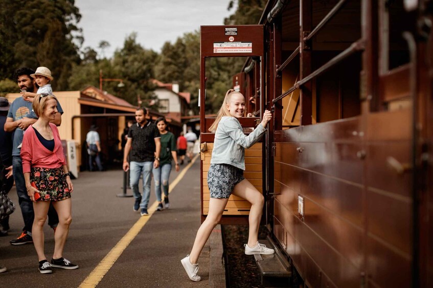 A train station platform with people boarding a train. 5