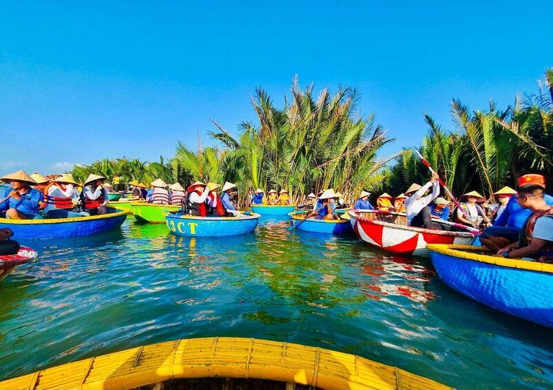 A group of people in colorful boats on a body of water, surrounded by palm trees. 4