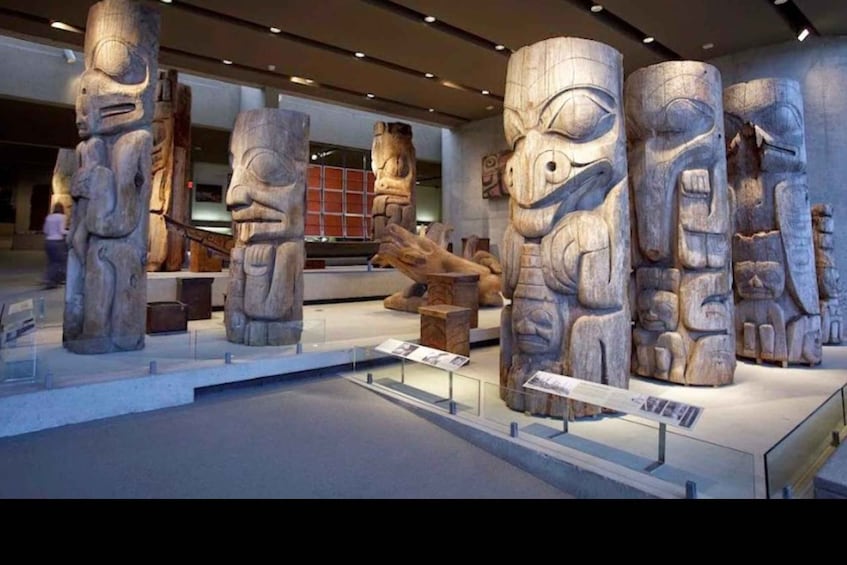 A museum exhibit with large stone carvings of ancient figures. 2