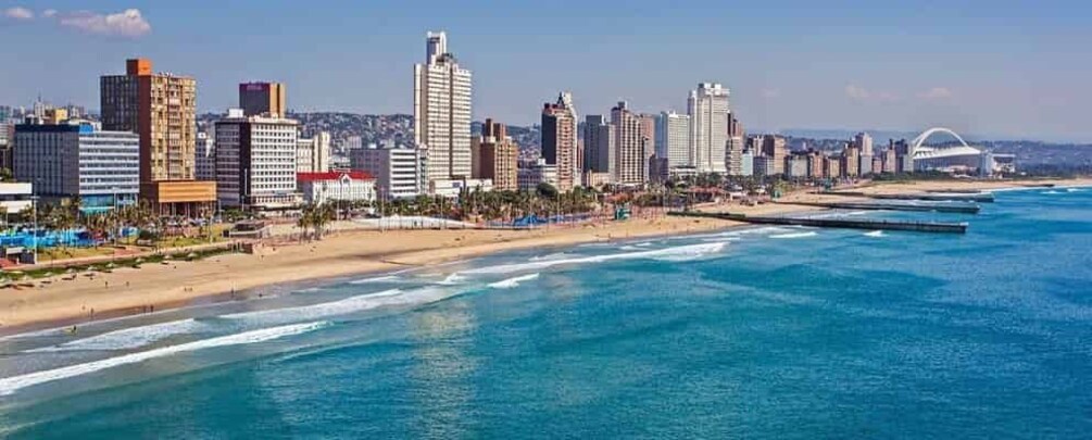 A coastal cityscape with a beach, ocean, and high-rise buildings. 5
