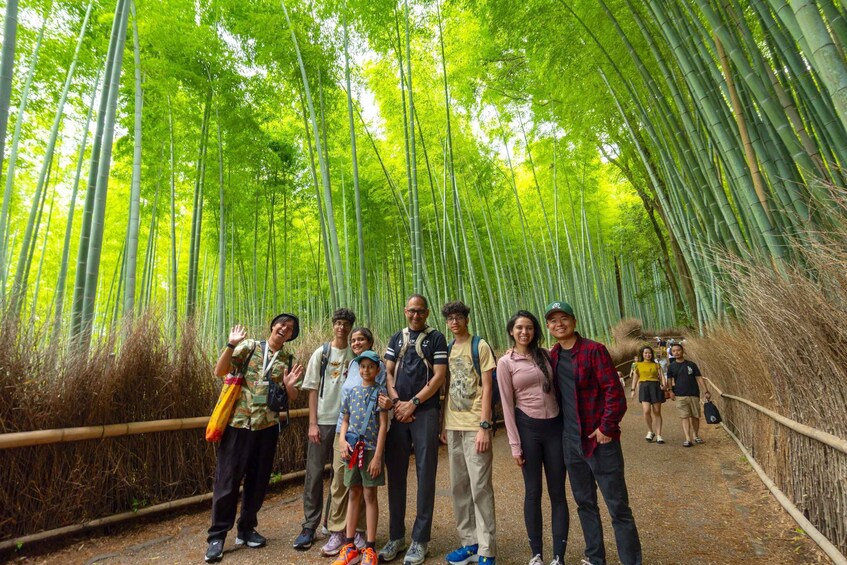 A group of people standing on a bamboo forest path. 3
