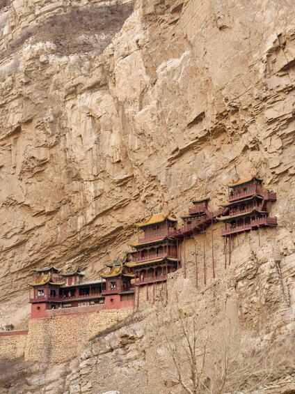 A series of traditional Chinese buildings built into a cliffside. 1