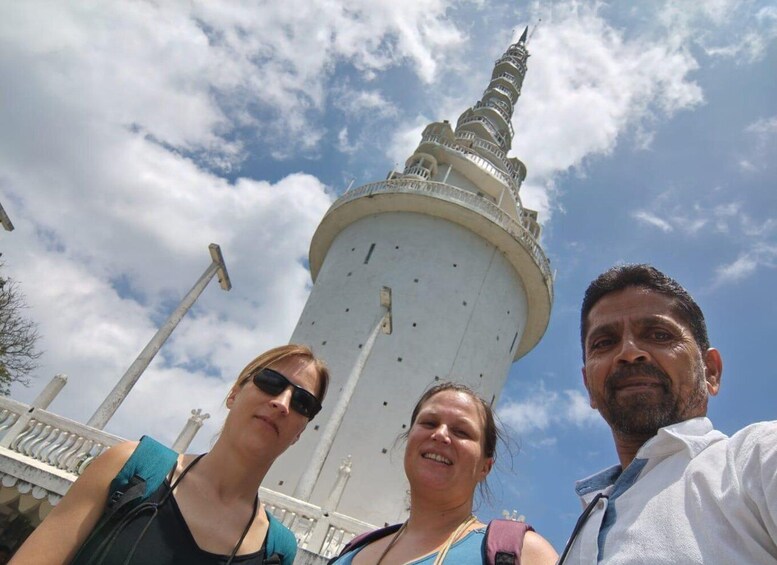 A tower with a spiral staircase, a clear sky, and a person in a white shirt. 2