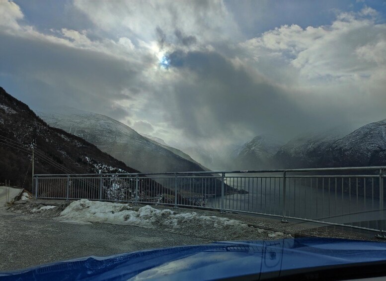 A snow-covered mountain landscape with a bridge and a body of water. 3