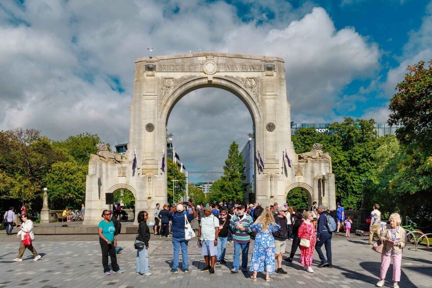 A large stone archway with the inscription "Bridge of Remembrance" in a public square with people walking around. 4
