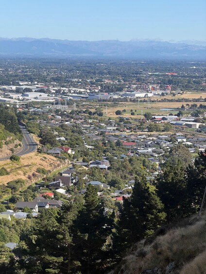 A town with residential houses, industrial buildings, and a highway curving through the landscape. 3