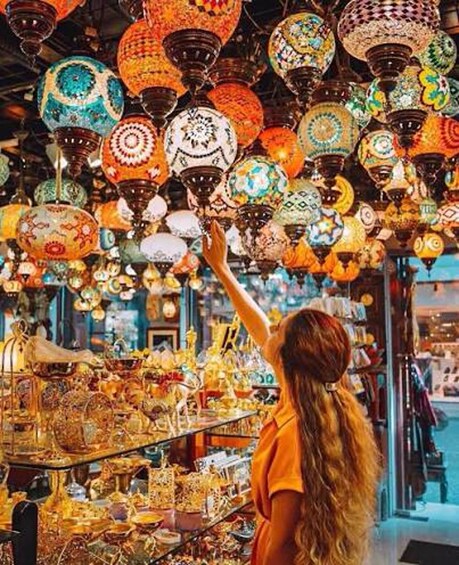 A person browsing a market filled with colorful lanterns. 2