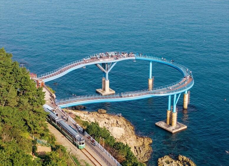 A curved bridge over water with people walking on it. 4