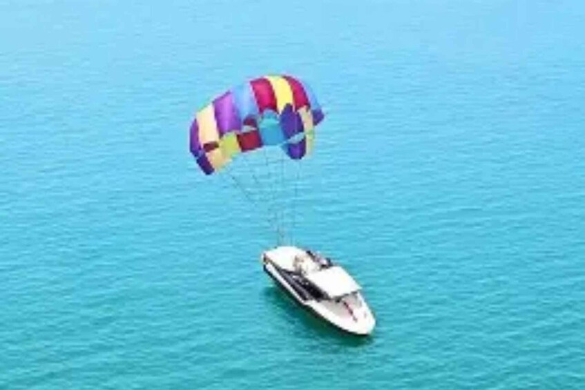 A parasailing boat with a colorful canopy over the water. 5