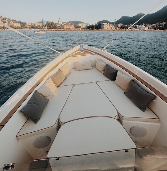 A boat with a cushioned seating area and a table in the middle. 1