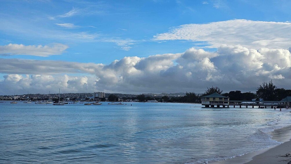 A coastal scene with a pier, boats, and a cityscape in the background. 5