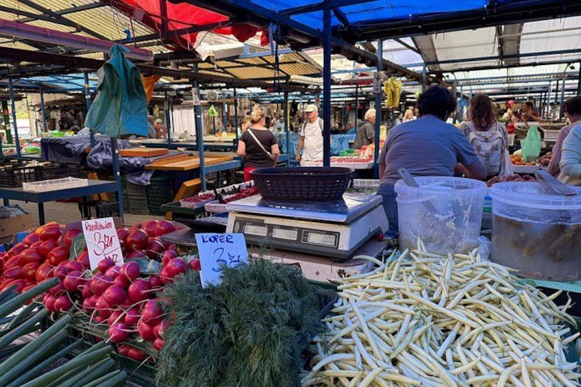 A market with fresh produce, including radishes and beans, and a weighing scale. 3