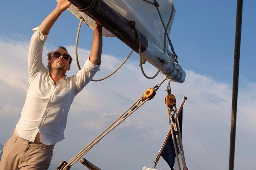 A person handling a sail on a boat. 4