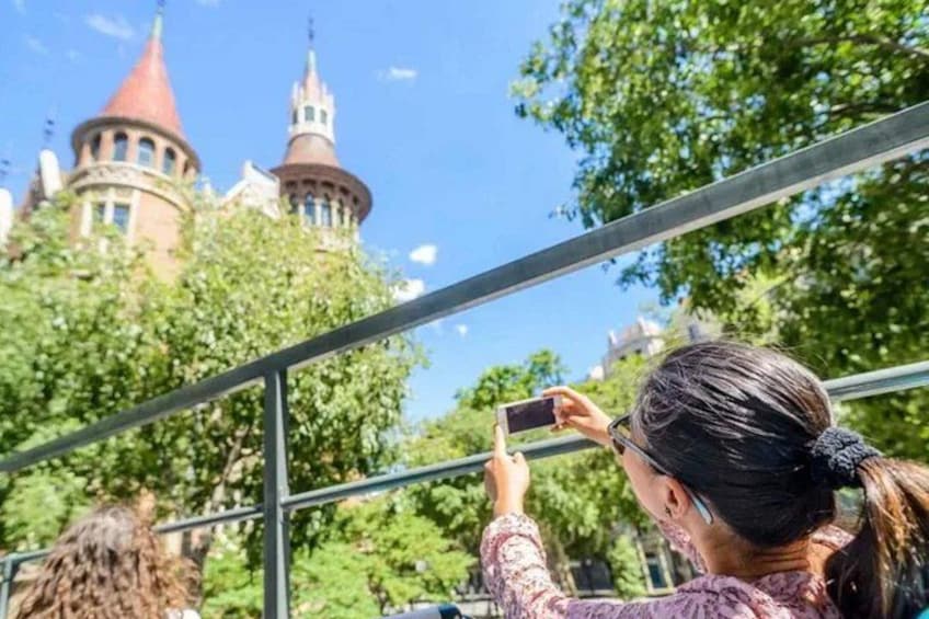 A person taking a photo of a castle with red towers. 2