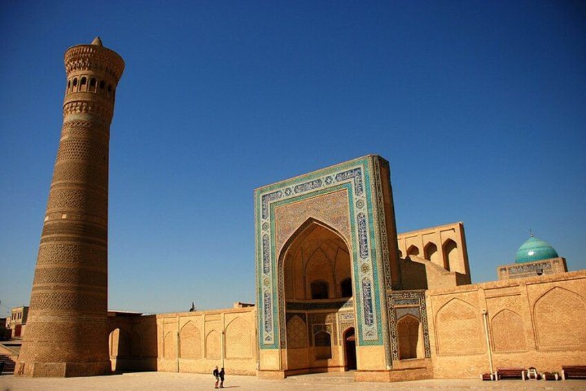 A historic building with a tall minaret and an ornate entrance. 3