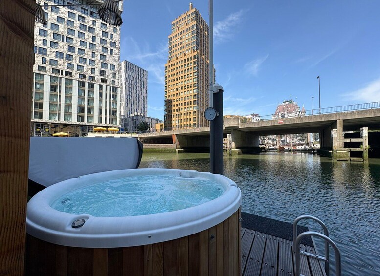 A hot tub on a deck with a cityscape and a bridge in the background. 2