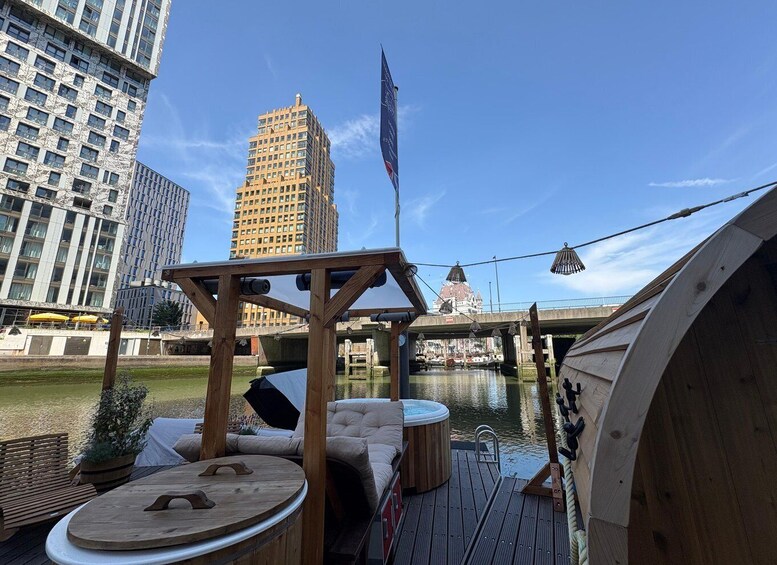 A wooden deck with outdoor seating, a hot tub, and a flagpole. 4