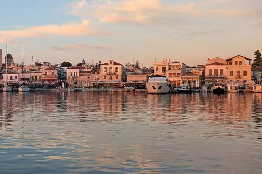 A coastal town with buildings, a bridge, and boats on the water. 3