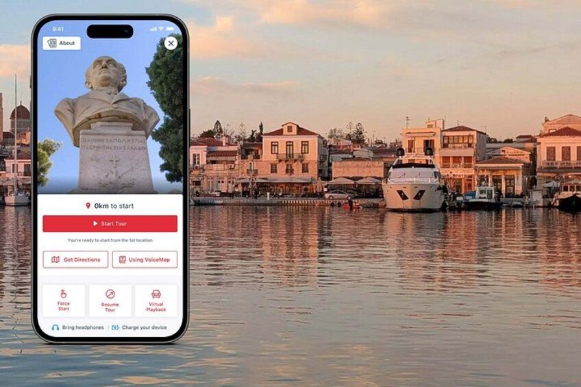 Un teléfono inteligente muestra una aplicación turística con una estatua y edificios cerca del agua. 1