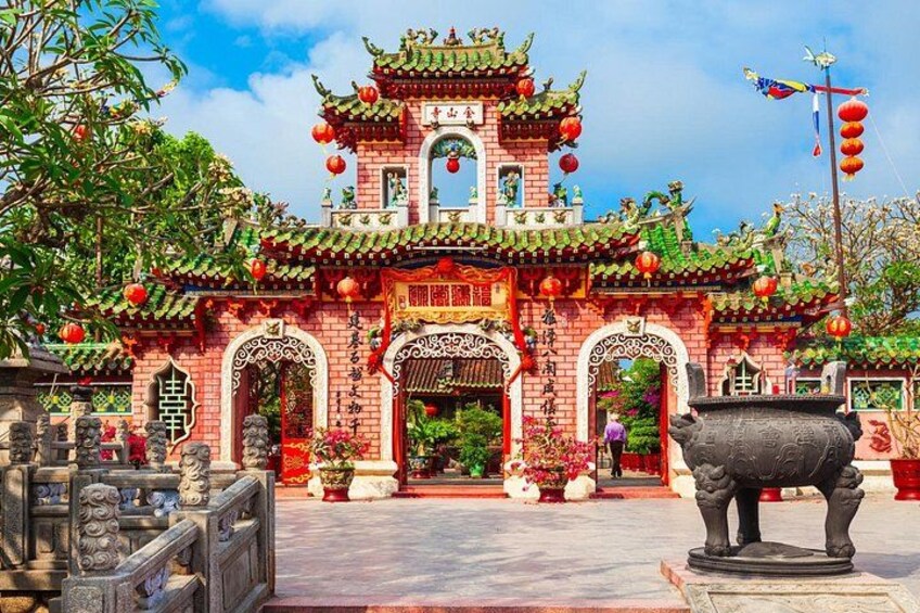 A traditional Chinese temple with ornate architecture, red lanterns, and a large stone bull statue in front. 5