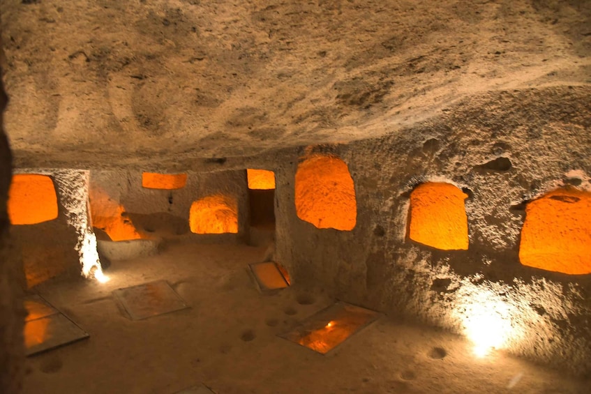 An interior with rough, uneven walls and small, rectangular openings. 3