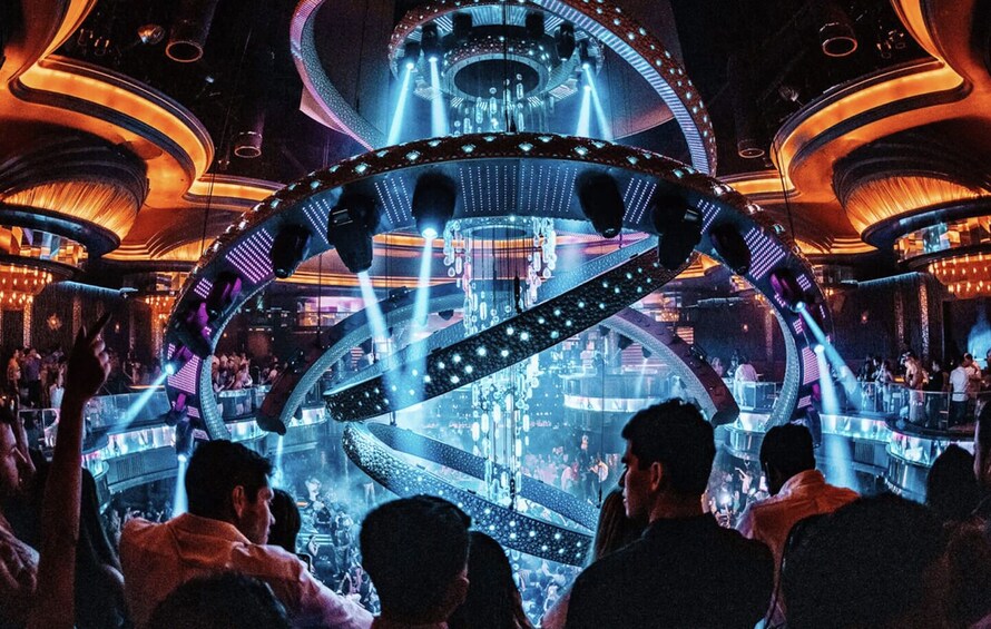 A concert with a large, illuminated stage and a crowd of people. 1
