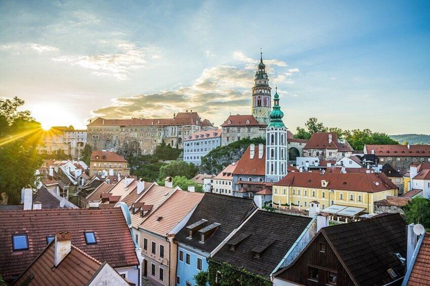 A cityscape with historic buildings, a prominent tower, and a clear sky. 5
