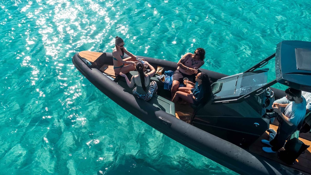 A group of people on a boat in clear turquoise water. 5