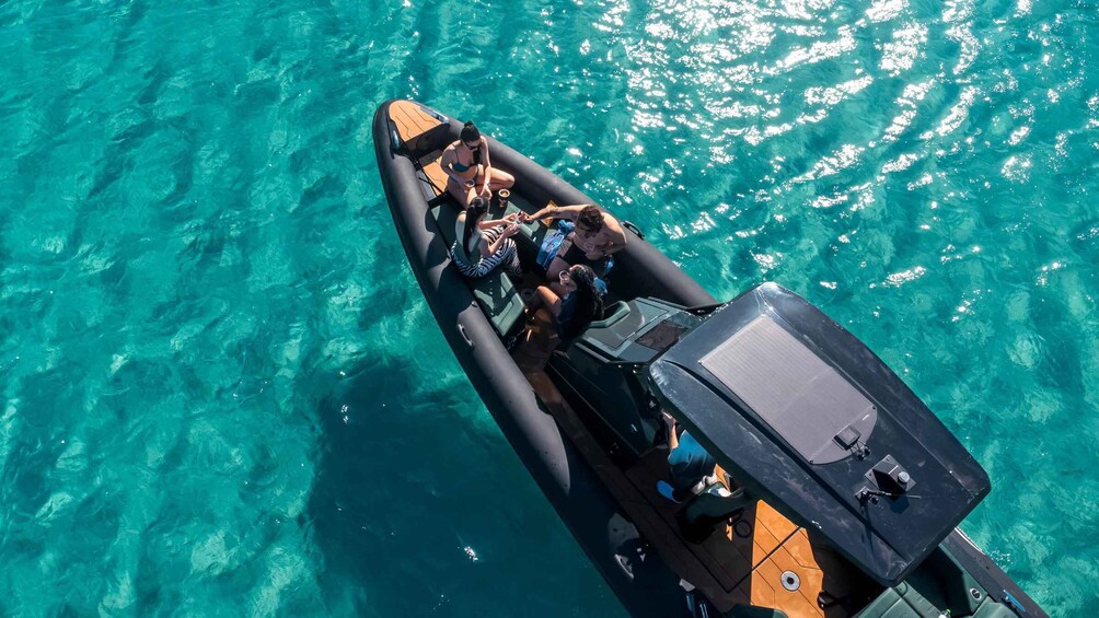 A small inflatable boat on clear turquoise water. 1