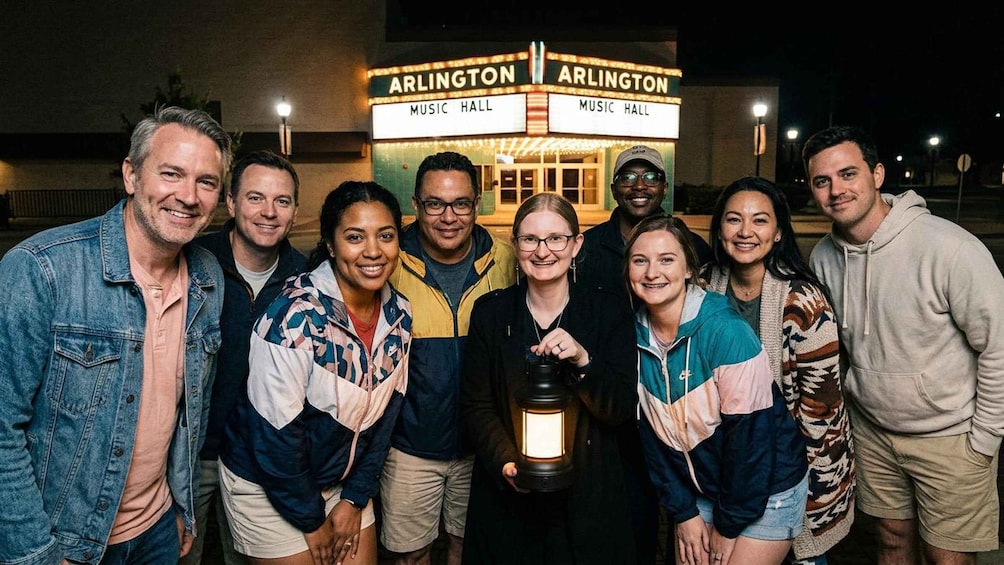 A group of people posing in front of a building labeled 'ARLINGTON MUSIC HALL.' 3