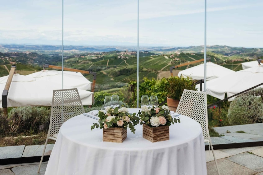 A table set outdoors with a scenic view of rolling hills in the background. 5