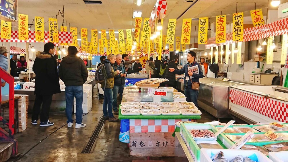 A busy fish market with yellow banners and checkered patterns. 3