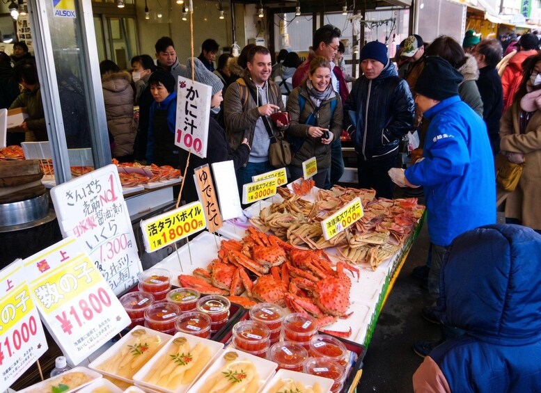 A seafood market with various seafood displayed and signs indicating prices. 4